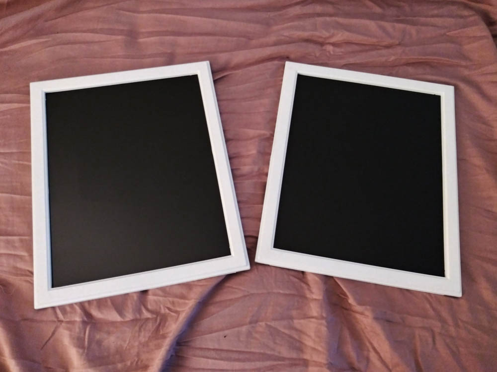 Two finished black mirrors.